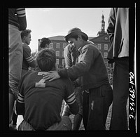 Washington, D.C. Team manager talking to a player who has just come out of a football game at Woodrow Wilson High School. Sourced from the Library of Congress.