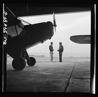 Frederick, Maryland. Walter Spangenberg, a student at Woodrow Wilson High School, talking to a friend at the Stevens Airport where he takes lessons. Sourced from the Library of Congress.