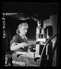 Boeing aircraft plant, Seattle, Washington. Production of B-17F (Flying Fortress) bombing planes. Girl working on a machine. Sourced from the Library of Congress.