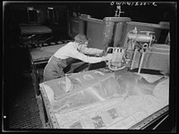 Boeing aircraft plant, Seattle, Washington. Production of B-17 (Flying Fortress) bombing planes. Worker operating a routing machine. Sourced from the Library of Congress.