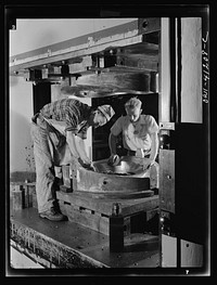 Boeing aircraft plant, Seattle, Washington. Production of B-17 (Flying Fortress) bombing planes. Kirksite dies for the forming of parts of the B-17 (Flying Fortress). Bombers are being finished in a hydraulic press. Sourced from the Library of Congress.