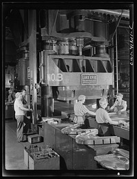 [Untitled photo, possibly related to: Boeing aircraft plant, Seattle, Washington. Production of B-17 (Flying Fortress) bombing planes. Kirksite dies for the forming of parts of the B-17 (Flying Fortress). Bombers are being finished in a hydraulic press]. Sourced from the Library of Congress.