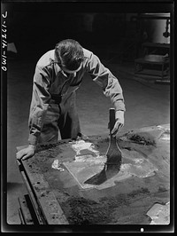Boeing aircraft plant, Seattle, Washington. Production of B-17 (Flying Fortress) bombing planes. Man working on a mold (?) for a part of the plane. Sourced from the Library of Congress.