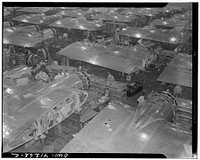 [Untitled photo, possibly related to: Boeing aircraft plant, Seattle, Washington. Production of B-17F (Flying Fortress) bombing planes. Wing section, each containing two Wright engines, await mating with fuselage section of the B-17F (Flying Fortress) bomber]. Sourced from the Library of Congress.