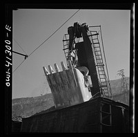 Bingham Canyon, Utah. Huge dipper of a power shovel loading ore into a car at a mine of the Utah Copper Company. Sourced from the Library of Congress.
