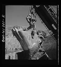 [Untitled photo, possibly related to: Bingham Canyon, Utah. Huge dipper of a shovel loading ore into cars at a mine of the Utah Copper Company]. Sourced from the Library of Congress.