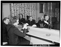 Washington, D.C. A group of WAVES (Women Accepted for Volunteer Emergency Service), just off a train, freshen up in the powder room at the United Nations service center. Sourced from the Library of Congress.