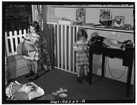 Washington, D.C. Children playing in the nursery at the United Nations service center while their mother makes arrangements for continuing their journey. Sourced from the Library of Congress.