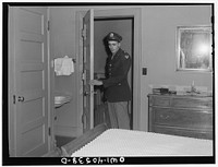 [Untitled photo, possibly related to: Washington, D.C. A lieutenant in the United States Army Air Transport Command calling the airport to check on flight conditions before checking out at the United Nations service center]. Sourced from the Library of Congress.