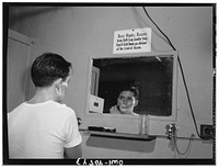 Washington, D.C. Without engaging a hotel room, traveling servicemen may take a shower, shave, and wash and iron clothes at the United Nations service center. Sourced from the Library of Congress.