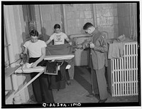 Washington, D.C. Servicemen using the laundry facilities in the sub-basement of the United Nations service center. It is not necessary to engage a hotel room in order to use these accommodations. Sourced from the Library of Congress.