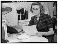 Washington, D.C. Lynn Massman, wife of a second class petty officer who is studying in Washington, writing letters while her baby is having his afternoon nap. Sourced from the Library of Congress.