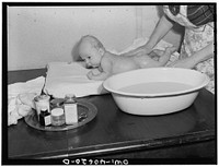 Washington, D.C. Eight weeks old Joey Massman, infant son of a petty officer, second class, who is studying in Washington, D.C., getting his daily bath. Sourced from the Library of Congress.