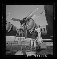 [Untitled photo, possibly related to: Boeing aircraft plant, Seattle, Washington. Production of B-17F (Flying Fortress) bombing planes. Lubricating and servicing a new B-17F (Flying Fortress) bombers.]. Sourced from the Library of Congress.