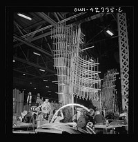 [Untitled photo, possibly related to: Seattle, Washington. Boeing aircraft plant. Production of B-17F (Flying Fortress) bombing planes. Sections of framework]. Sourced from the Library of Congress.