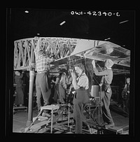 [Untitled photo, possibly related to: Boeing aircraft plant, Seattle, Washington. Production of B-17F (Flying Fortress) bombing planes. Women assembling a wing]. Sourced from the Library of Congress.