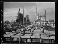 Columbia Steel Company at Geneva, Utah. Steel and concrete go into place rapidly as a new steel mill takes form. The new plant will make important additions to the vast amount of steel needed for the war effort. Sourced from the Library of Congress.