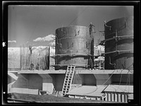 [Untitled photo, possibly related to: Columbia Steel Company at Geneva, Utah. The erecting crane is kept busy as blast furnaces take form in a new steel mill under construction which will make important additions to the vast amount of steel needed for the war effort]. Sourced from the Library of Congress.