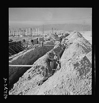 Columbia Steel Company at Geneva, Utah. Steel and concrete go into place rapidly as a new steel mill takes form. The new plant will make important additions to the vast amount of steel needed for the war effort. Sourced from the Library of Congress.