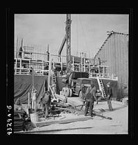 Columbia Steel Company at Geneva, Utah. Setting a pipe with a derrick during the construction of a new steel mill which will make important additions to the vast amount of steel needed for the war effort. Sourced from the Library of Congress.