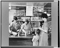 West Danville, Vermont. "What else will it be today, Mrs. Metcalf?" asks Mrs. Hastings, who has clerked in the general store owned by Mr. and Mrs. Hastings for twenty-nine years. Ronald Drown is looking on. Sourced from the Library of Congress.