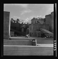Las Vegas, Nevada. A rear view of some of the structures of the Basic Magnesium Incorporated plant, showing at the far right of the picture two of the eighty-four foot silos used for the storage of ore. Great quantities of the lightest of all metals are produced at this plant for aircraft and other wartime manufacturing. Sourced from the Library of Congress.
