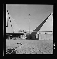 Las Vegas, Nevada. Two peat storage buildings, 540 by 100 feet, on the Basic Magnesium Incorporated grounds in the southern Nevada desert, which produces great quantities of the lightest of all metals for aircraft manufacture. Sourced from the Library of Congress.