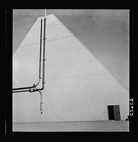 Las Vegas, Nevada. One side of a huge peat storage building on the Basic Magnesium Incorporated grounds in the southern Nevada desert, which produces great quantities of the lightest of all metals for aircraft manufacture. Sourced from the Library of Congress.