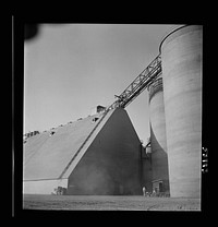 [Untitled photo, possibly related to: Las Vegas, Nevada. Giant silos, eighty-four feet high, for the storage of ore for the manufacture of magnesium at the Basic Magnesium Incorporated plant in the southern Nevada desert. A peat storage building can be seen at the left]. Sourced from the Library of Congress.