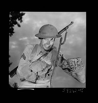 [Untitled photo, possibly related to: Fort Belvoir, Virginia. A soldier handling barbed wire with special gloves which are clasped instead of sewn together]. Sourced from the Library of Congress.