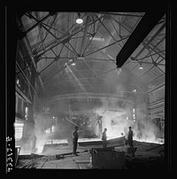 [Untitled photo, possibly related to: Columbia Steel Company at Ironton, Utah. Tapping a heat of iron in the cast house of the blast furnace]. Sourced from the Library of Congress.