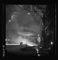 [Untitled photo, possibly related to: Columbia Steel Company at Ironton, Utah. Tapping a heat of iron in the cast house of the blast furnace]. Sourced from the Library of Congress.