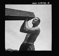  laborers carrying and laying railroad ties for a spur line into a coal storage space for the federal government. Sourced from the Library of Congress.