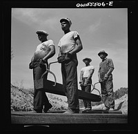 [Untitled photo, possibly related to:  laborers carrying and laying railroad ties for a spur line into a coal storage space for the federal government]. Sourced from the Library of Congress.