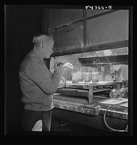 Kingman (vicinity), Arizona. Mr. Relling, scientist in the laboratory of a concentrating plant, analyzing tungsten ore over a hot plate. Sourced from the Library of Congress.