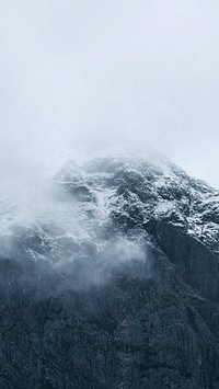Nature phone wallpaper background, snowy mountain on a misty day