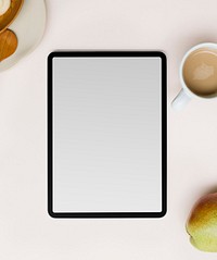 Blank tablet screen flat lay by coffee cup