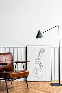 Picture frame with line art by a lamp in a living room