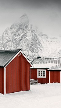 Winter mobile wallpaper background, red cabins on a snowy Sakrisoy island, Norway