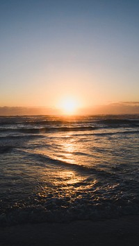 Nature mobile wallpaper background, sun setting over a sea