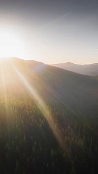 Nature iPhone wallpaper background, sunbeam over a top of green mountains