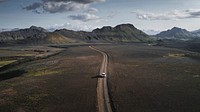 Nature desktop wallpaper background, SUV car driving in the countryside drone shot