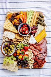 Charcuterie board with cold cuts, fresh fruits and cheese close up