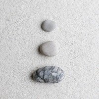 Marble zen stones stacked on white background in stability concept