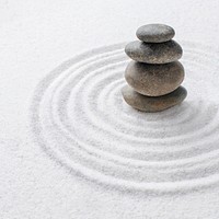 Stacked zen stones sand background art of balance concept