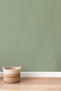 Rattan basket by a green wall background