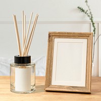 Blank decorative picture frame on wooden table