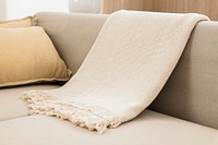 White woven throw blanket on sofa