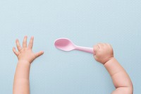 Baby hands background holding spoon pink plastic image