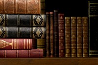 Antique books on wooden shelf, vintage background